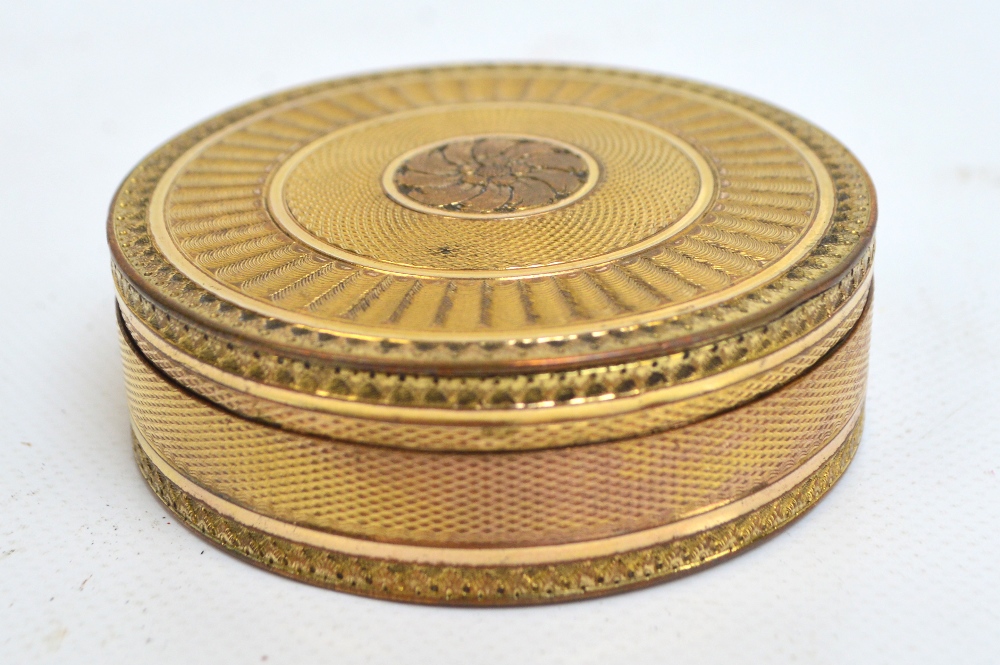 A 19th century French gilt metal box with overall engine turned decoration centred with a floral