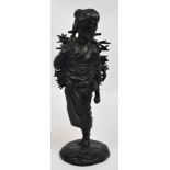 A Japanese Meiji period bronze figure of a female carrying a bundle of twigs upon her back,