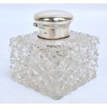 An Edward VII hallmarked silver mounted clear hobnail cut glass inkwell of square section,