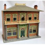 A Victorian timber doll's house with two section hinged front with columns,