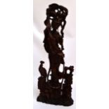 A large 20th century Chinese carved wooden figure of a female musician playing sheng (reed pipes),
