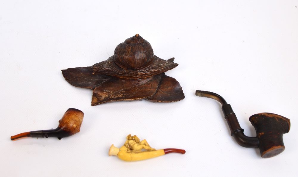 A late 19th/early 20th century Black Forest carved wooden inkwell modelled as a snail on leaves