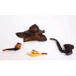 A late 19th/early 20th century Black Forest carved wooden inkwell modelled as a snail on leaves