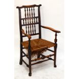 A North Country spindle back rush seated elbow chair with stretchered supports and front pad feet,