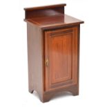 An Edwardian mahogany and inlaid bedside table with raised back and rectangular top above single
