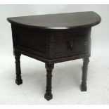 An oak hall credence type hall table, the D-shaped top above a door on turned supports, width 98cm.