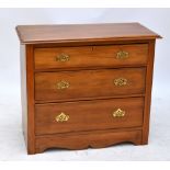 An Edwardian walnut chest of three long drawers, formerly the base of a dressing chest, width 91cm.