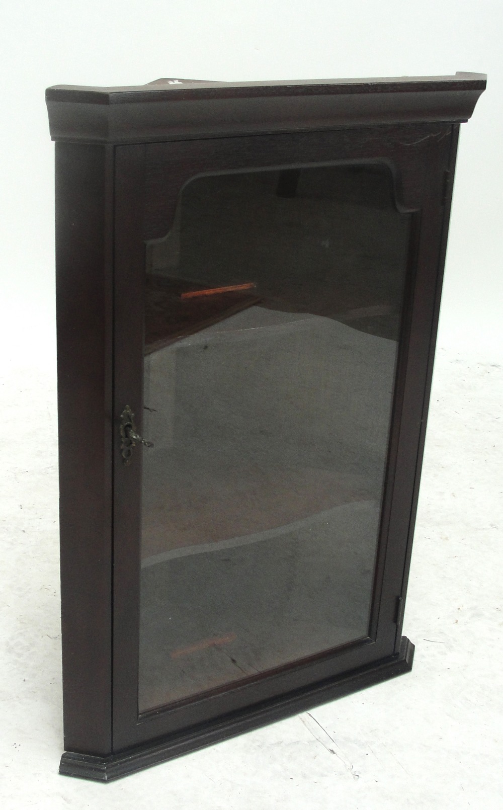 A reproduction mahogany glazed flat fronted corner cupboard of small proportions.