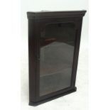 A reproduction mahogany glazed flat fronted corner cupboard of small proportions.