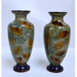 A near pair of Royal Doulton leaf decorated stoneware vases, both with impressed marks to base,