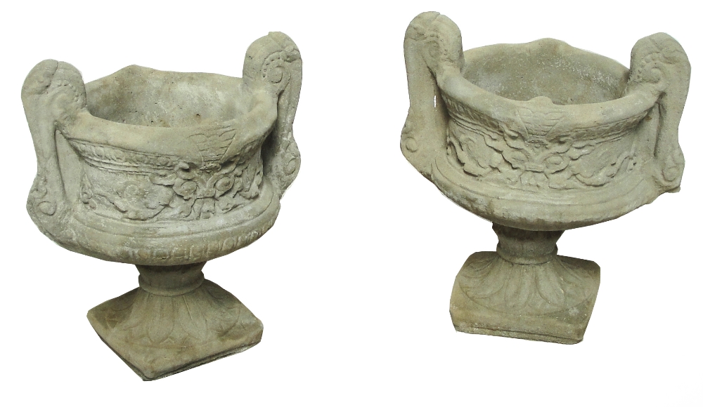 A pair of modern concrete twin handled urns on socle bases.