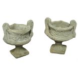 A pair of modern concrete twin handled urns on socle bases.