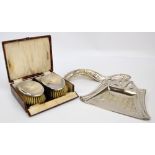 A cased pair of George V hallmarked silver backed brushes with overall engine turned decoration