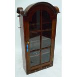 A reproduction domed bookcase with single glazed door above twin candle slides, width 64cm.