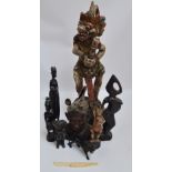 A collection of carvings including Balinese head, various African items, etc (9).