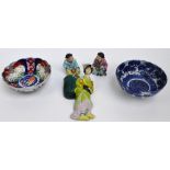 A pair of 20th century Chinese porcelain and enamel decorated figures of seated children,