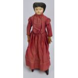 An early 19th century doll with papier-mâché painted face, with leather hands and shoes,