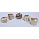 A George VI hallmarked silver napkin ring, London 1945, two further hallmarked silver napkin rings,