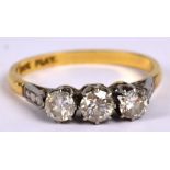 An 18ct yellow gold and diamond three stone ring with platinum high claw setting,