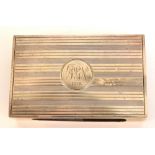 A George V hallmarked silver match book case of plain rectangular form with engine turned