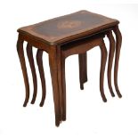 A nest of three walnut and floral inlaid occasional tables of shaped rectangular form,