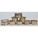 Four pairs of George V hallmarked silver circular napkin rings to include a waisted bead decorated