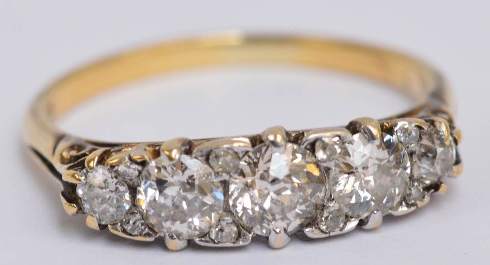 An 18ct yellow gold diamond graduated five stone ring, the central stone approx 0.
