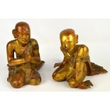 A pair of Mandalay period Burmese gilt lacquered wooden seated disciple figures, tallest 32cm,