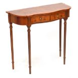 A reproduction yew wood serpentine fronted two drawer hall table on four turned and fluted legs,