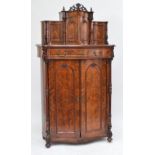 A 19th century European walnut serpentine front cabinet,