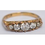 An 18ct yellow gold and diamond graduated five stone ring, the central stone approx 0.
