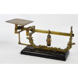 A J & E Ratcliff brass steelyard balance scale raised on rounded rectangular plinth base,
