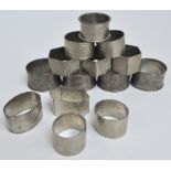 A collection of various pewter napkin rings to include a Tudric hexagonal hammer decorated example,