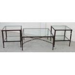 A glass top metal frame occasional table with ornate scrolling supports,
