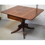 An early 19th century mahogany centre pedestal Pembroke table with moulded decoration to the frieze