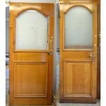 Two oak doors with arched opaque glass top over lower panel with some original door furniture,