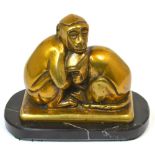 An early 20th century Japanese bronzed figure group of two monkeys raised on a polished oval base,