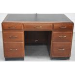 A black leather inset seven drawer desk of simple form, width 128cm.