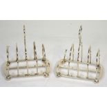 A pair of George V Walker & Hall hallmarked silver toast racks, both Sheffield 1923, one af,