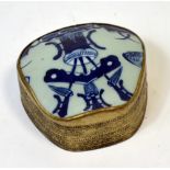 A white metal Oriental box and cover with early Chinese pottery insert to the top,