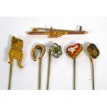 Five Edwardian stick pins, one with a dog finial, one yellow metal with a horseshoe finial,