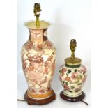 Two Oriental style baluster table lamps on wooden stands, the largest height 39cm (2).
