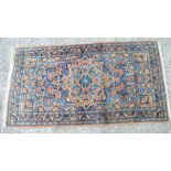 A beige ground Kirman rug, approx 210 x 122cm,