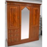 An Edwardian mahogany and satinwood inlaid wardrobe, the moulded cornice above dentil inlaid frieze,