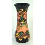 A Moorcroft 'Honeysuckle' baluster vase with marks to the base, height 21cm.