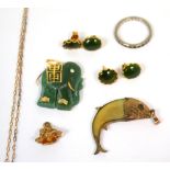 A small fish pendant with yellow metal decoration, a jadeite elephant with yellow metal decoration,