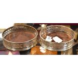 A pair of George III hallmarked silver bottle coasters with turned wooden bases and pierced frames,