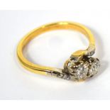 A ladies' 18ct gold ring with two diamonds on a twist, size L, approx 3g.