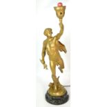 An Art Deco spelter lamp of a man in classical style holding aloft a lamp, marked to the base E.