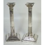 A pair of hallmarked silver Corinthian style loaded candlesticks, Sheffield, date letter rubbed,